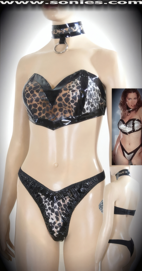 Seize the Moment or the Man when You Appear in this Show Stopper Black Bordered and Tan Leopard Print Two Tone Patent Leather (PVC) Three Piece Set. Neck Choker with Large Metal O-Ring Front Accent and Adjustable Metal Snap Back Closure. V-Neckline Bandeau Style Crop Top with Center Boning on Cups to Enhance the Bust, Adjustable Hook & Eye Back Close for Off and On Ease Detail Finish. Complete with Matching V-Front Unlined Crotch Bottom and Stretch Satin Lycra Thong Back Finally.    Style: 1901