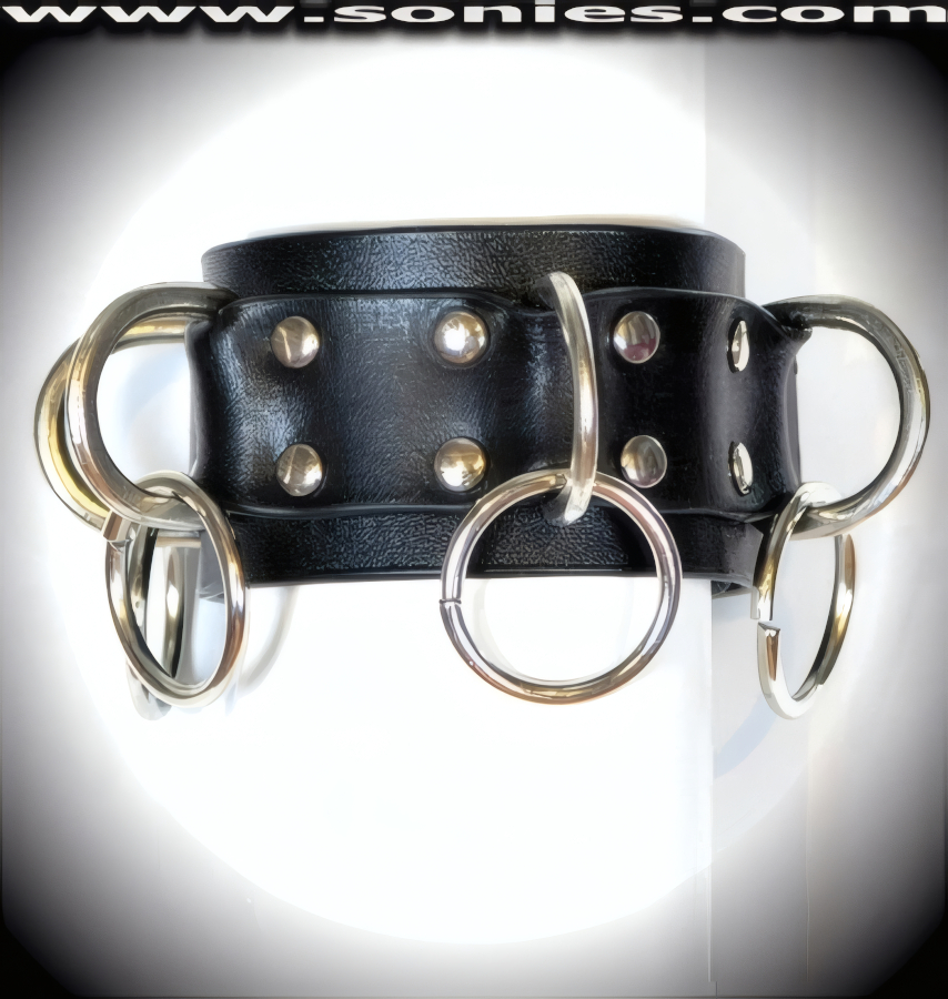 Dominate with extra added attitude wearing the magnificent black Taurus handmade leather wristband. Crafted with 8 large metal D-rings that are linked by 8 metal large O-rings for extra added impressment, plus rivets on all stress points and adjustable dual metal snaps closure to ensure a great fit. This style looks great with anything you wear and is perfect for stage, life style events, pride week, monthly play parties, fetish events and adult alternative lifestyle gatherings.   Style: WR000