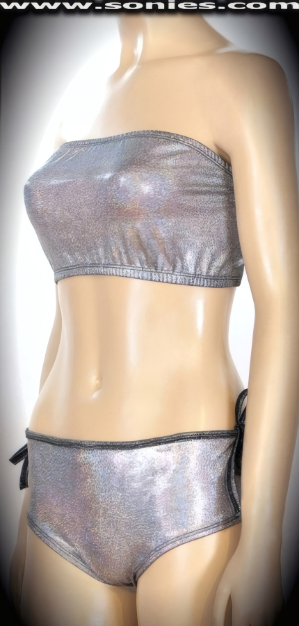Bring on the night in this magnificent Rumi�ahui two piece stretch glimmer hologram Lycra set. Curvature embracing tube top that is designed to fit all busts magnificently. Includes a matching center stage dance wear curve hugging pull-on cheeky hot pants with skin baring keyhole sides and tie straps detail finish to ensure a great fit. The low rise design makes the torso look longer, while the high-cut thigh elongates the legs, for an incredibly seductive silhouette (15% Lycra, 85% Nylon). It pairs beautifully with any number of risqu� gloves. May be worn with stiletto heel shoes or boots to create a phenomenal look. This style is perfect for stage, life style events, pride week, monthly play parties, fetish events, adult alternative lifestyle gatherings, bachelor parties, club wear, nightclubs, dance clubs and gentleman's clubs.   Style: 8003AHO
