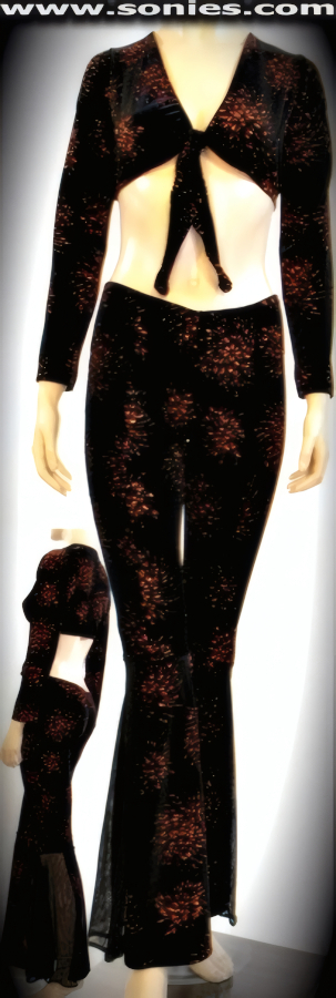 Heart Hammering in Our Ladies Calypso Fireworks Glitter Copper Foil Stretch Velvet Two Piece Set. Long Sleeved Tie Front Crop Top and Complementing Pull-On Pant with Translucent Illusion Mesh Bell Bottom Sides Detail Finish.   STYLE: 975-033SC