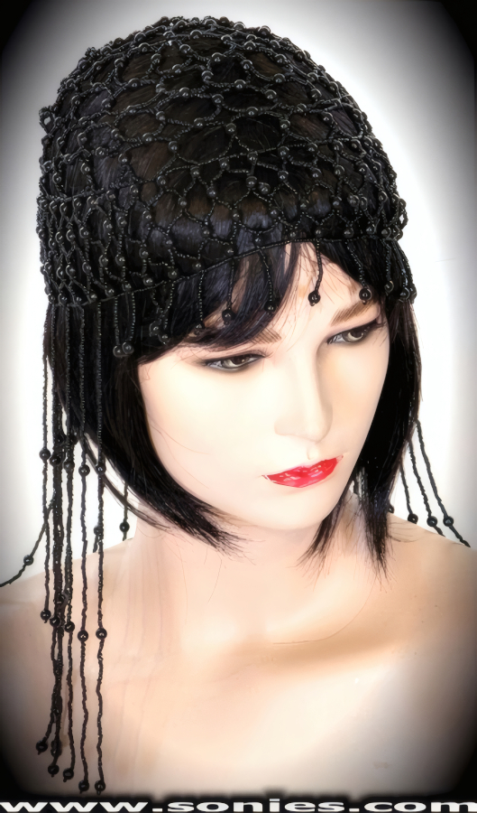 Be the envy of all wearing this dramatic Sumaco Egyptian-style headpiece that is magnificently crafted to liven up any outfit. Hand woven with small and large iridescent beads. Finished with detailed short on front and extra long on back beaded fringe.   Style: BTBC-01A