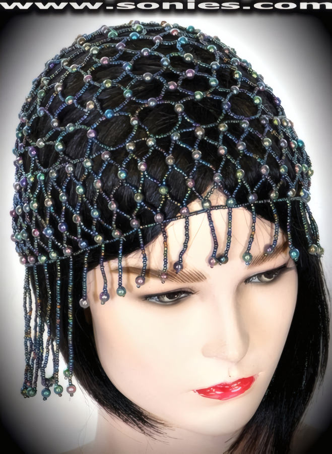 Bound for an evening of pleasure wearing this dramatic Pasochoa Egyptian-style headpiece that is gorgeously crafted to liven up any outfit. Hand woven with small and large iridescent beads. Finished with detailed short on front and long on back beaded fringe.   Style: BTBC-01B