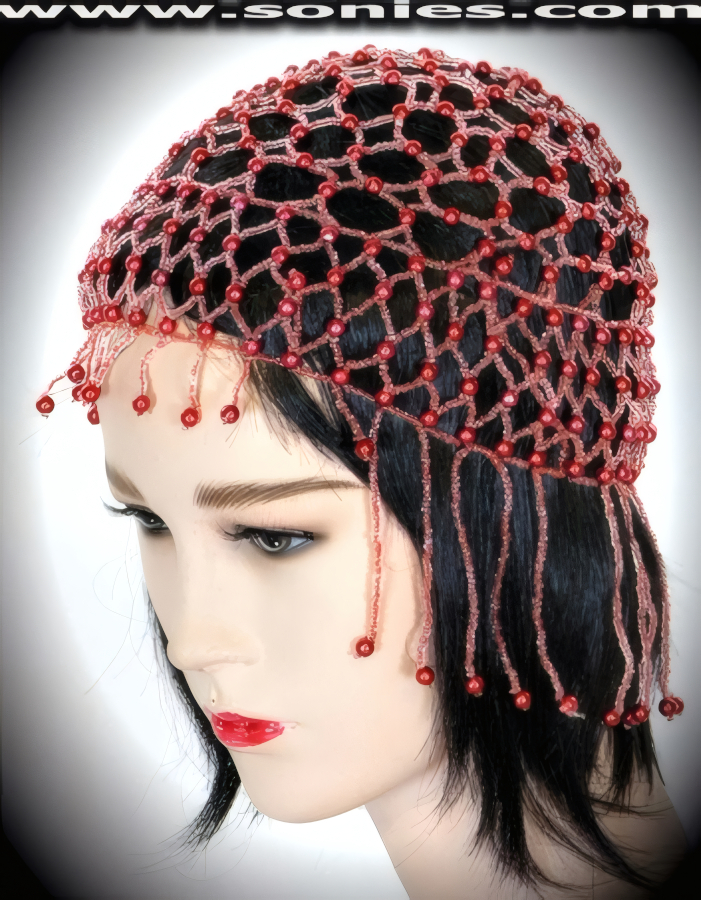 Captivate his attention wearing this dramatic Atacazo Egyptian-style headpiece that is resplendently crafted to liven up any outfit. Hand woven with small and large iridescent beads. Finished with detailed short on front and long on back beaded fringe.   Style: BTBC-01C