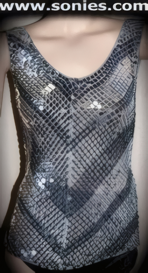 Irresistible and quite alluring in this Renaissance translucent dual gray tone hand crocheted sleeveless slip-on tank style top with glittery silver sequins detailing finish throughout to create an impressive look (63% Rayon, 33% Polyester, 4% Lycra. Hand wash cold and line dry. Do not bleach). It pairs beautifully with any number of bottoms such as skirts or trousers. May be worn with stiletto heel shoes or boots to create a phenomenal look. This style is suitable for evening wear, day wear, special occasions and club wear.   Style: BWT008
