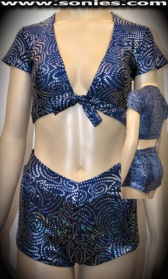 Wrap yourself in this brilliant Minya Konka two piece silver Aztec swirl stretch foil Lycra set. Seductive short sleeve crop top with tie front closure for off and on ease plus to ensure a great fit. Complete with matching curve hugging cheeky V-front pull-on hot pants (15% Lycra, 85% Nylon). It pairs beautifully with any number of risqu� gloves. May be worn with stiletto heel shoes or boots to create a phenomenal look. This style is perfect for stage, life style events, pride week, monthly play parties, fetish events, adult alternative lifestyle gatherings, bachelor parties, club wear, nightclubs, dance clubs and gentleman's clubs.   Style: CLS-901C