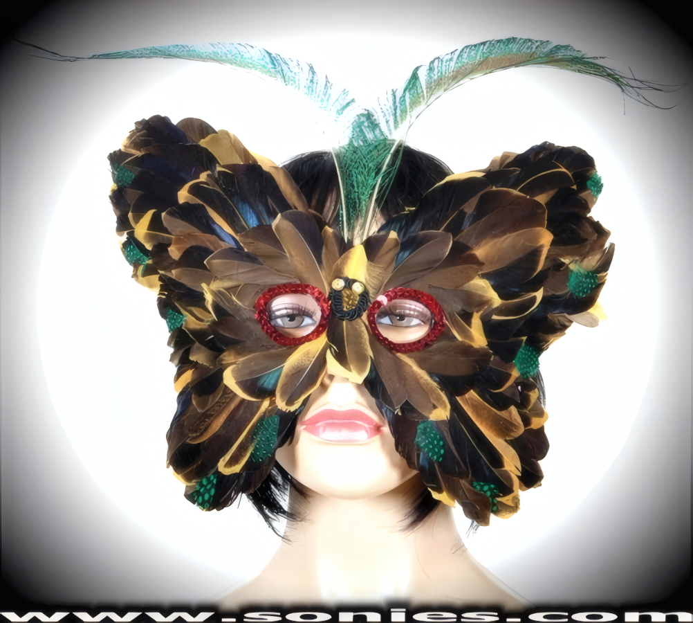 If you really want to create an impact at your next event then Our Victoria Countess Mask is for you. Gorgeous array of deluxe feathers that frame the face in a burst of Golden Tan, Blue and Green with Red Sequin Detail Finish around the Eyes. Attaches to the head with two elasticized straps around the back for a comfortable fit. A must have costume accessory for any street carnival, Vegas showgirl costume or theatrical production.   Style: MASK010