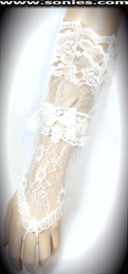Glamorous Vesta European floral lace short fingerless gloves. Gorgeous floral lace pattern with middle finger loop, large ruffle lace wrist, satin bow plus rhinestone center detail finish. Adds an elegant touch to your attire. Dainty lace fingerless gloves have a playful ambiance, much more so than formal opera length gloves. This style is perfect for formal, bridal, prom, d�butante and Opera Ball.   Style: MFG-72803A