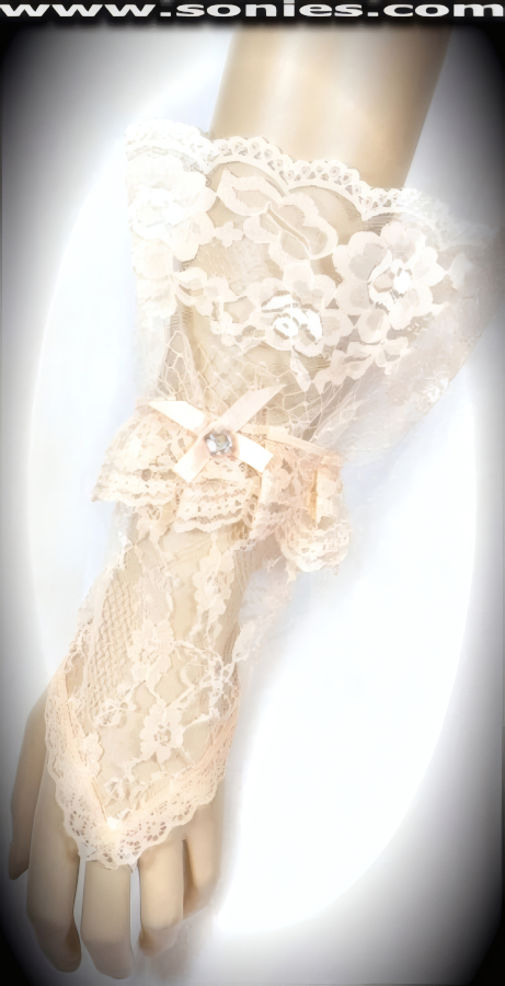 Glamorous Vesta European floral lace short fingerless gloves. Gorgeous floral lace pattern with middle finger loop, large ruffle lace wrist, satin bow plus rhinestone center detail finish. Adds an elegant touch to your attire. Dainty lace fingerless gloves have a playful ambiance, much more so than formal opera length gloves. This style is perfect for formal, bridal, prom, d�butante and Opera Ball.   Style: MFG-72803B