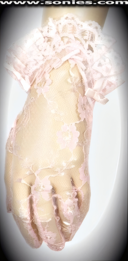 Show no mercy in these dreamy Furiae wrist length lace gloves with satin bow sides and curved ruffled cuff detail finish. Dainty lace gloves have a playful ambiance, much more so than formal opera length gloves. This style is perfect for formal, bridal, prom, d�butante and Opera Ball.   Style: MFG-72812