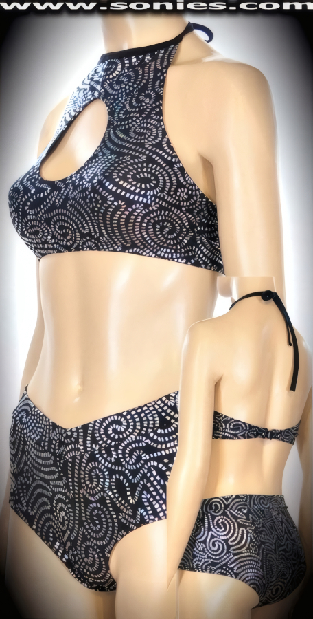 Get the thumbs up wearing this Pichincha well-sculpted three piece stretch glimmer silver Aztec swirl foil Lycra set. Curvature hugging halter style crop top with skin baring keyhole front, adjustable tie neck spaghetti straps to ensure a great fit, plus rear clasp closure for off and on ease detail finish. Complementing hip hugging pull-on V-front cheeky hot pants. Includes a matching thong back center stage micro dance wear panty with lined crotch to complete this magnificent vesture (15% Lycra, 85% Nylon). It pairs beautifully with any number of risqu� gloves. May be worn with stiletto heel shoes or boots to create a phenomenal look. This style is perfect for stage, life style events, pride week, monthly play parties, fetish events, adult alternative lifestyle gatherings, bachelor parties, club wear, nightclubs, dance clubs and gentleman's clubs.   Style: SC-16L