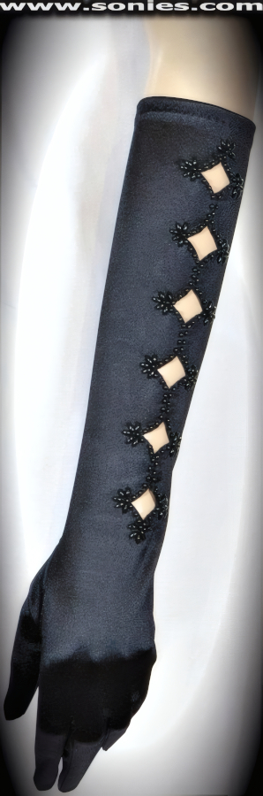 You'll be to hot to handle in these devastatingly beautiful Roraima stretch satin Lycra elbow length gloves with revealing beaded diamond shape openings (15% Lycra, 85% Nylon). It pairs beautifully with any number of vestures. This style is perfect for formal, bridal, prom, d�butante, Opera Ball, plus for professional entertainers such as can-can dancers and burlesque performers (particularly to perform a gown-and-glove dance).   Style: SG-0434