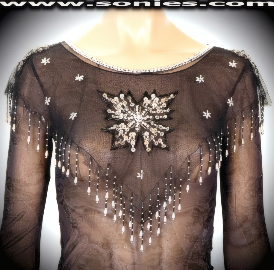 Lavish Yourself in this Stardom Elegant Shoulder Draping Capelet or Shoulder Cover. Created using Sheer Fine, Soft Netting and Hand Woven with Iridescent Beads and Sequins. Three Row Shimmering Beaded Collar Edging. Eye-Captivating Elaborate Design Large Center Star on Front and Back, created using Sequins with Intricately woven Beads. Tassel Fringe Hem wrapped with Tiny Distinctive Beads Detail Finish.   Style: WN102